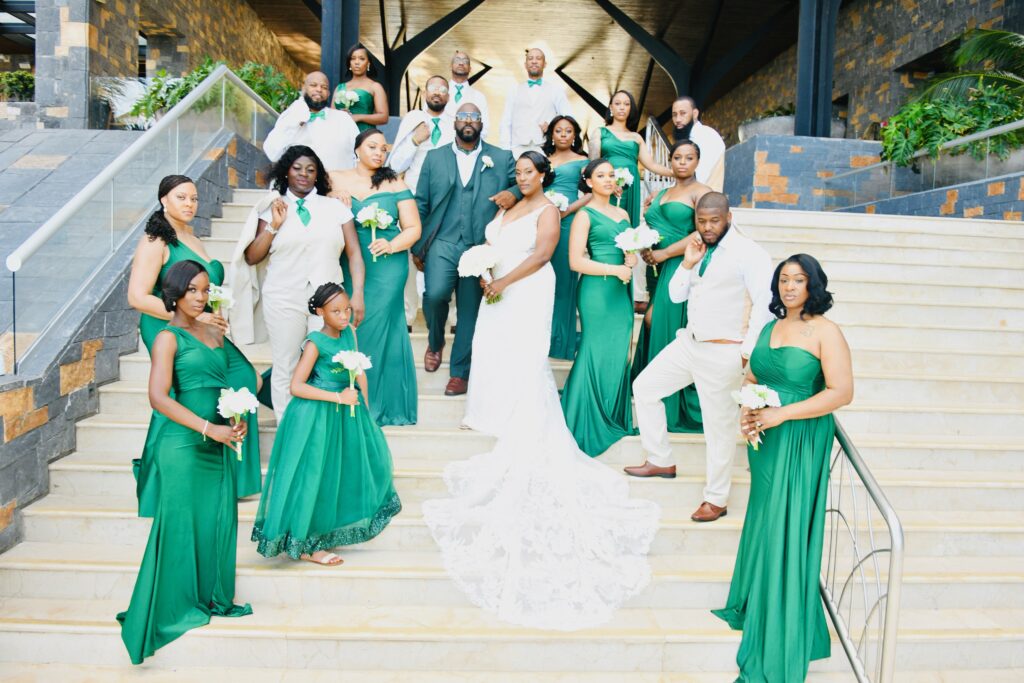 The destination wedding bridal party on the steps at Dreams Natura Resort & Spa in Riviera Cancun, Mexico