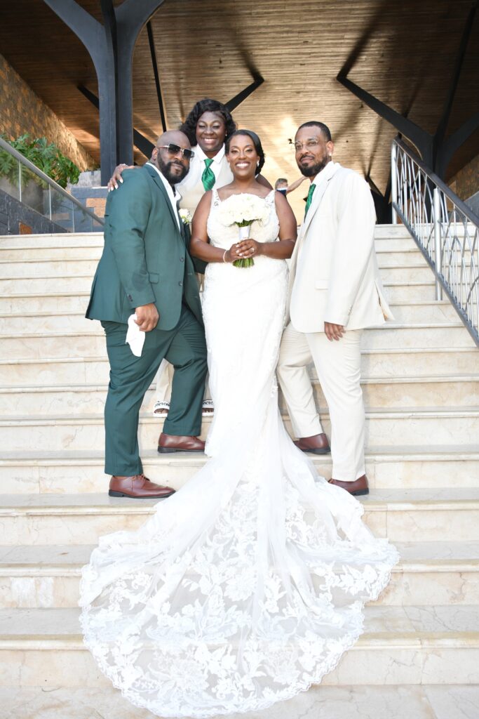 The destination wedding Bride and Groom on the steps at Dreams Natura Resort & Spa in Riviera Cancun, Mexico