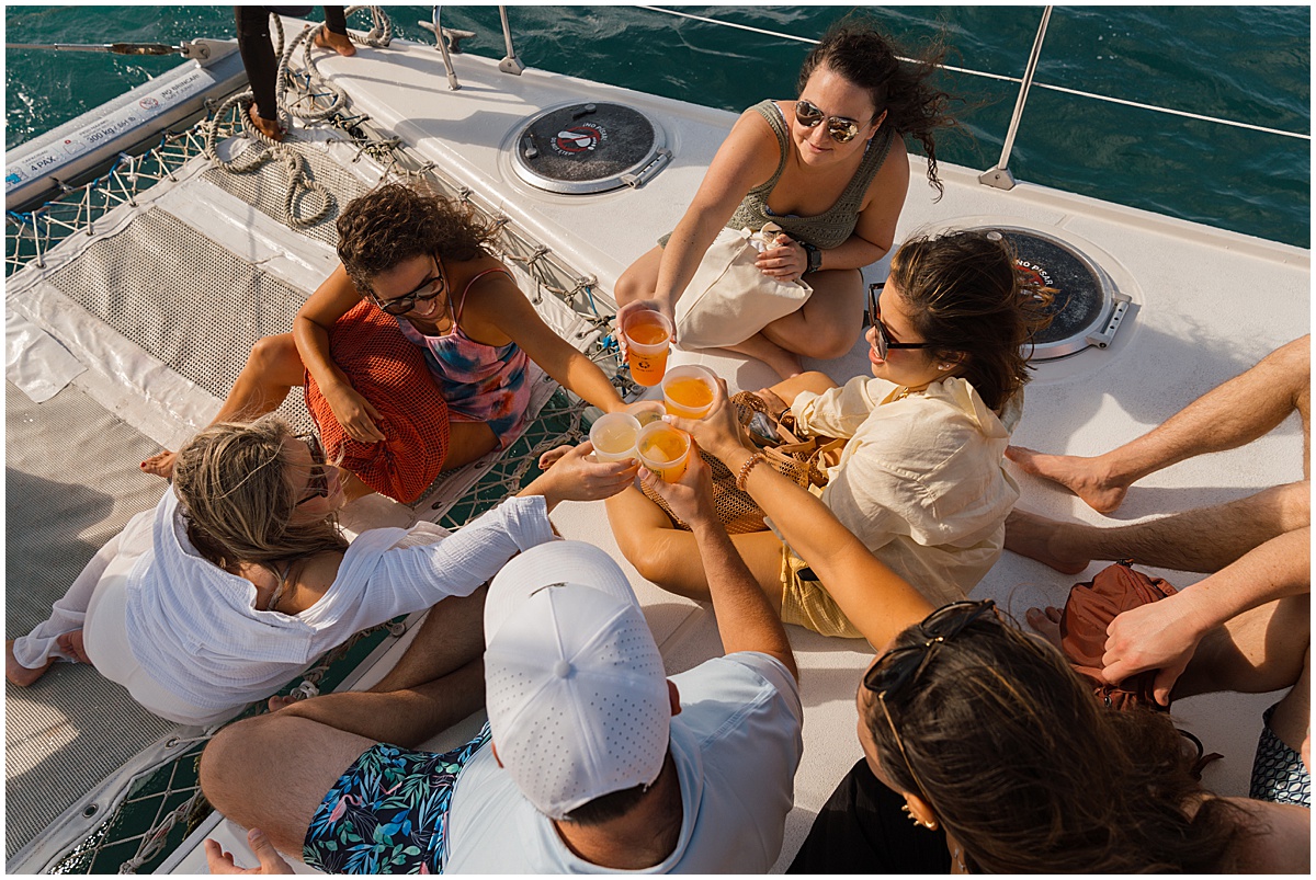 Wedding guests on a catamaran cruise as part of a destination wedding activities