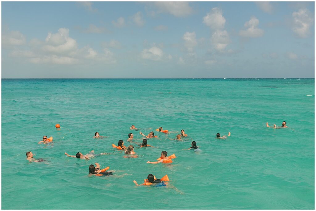 Wedding guests floating in the sea in Mexico