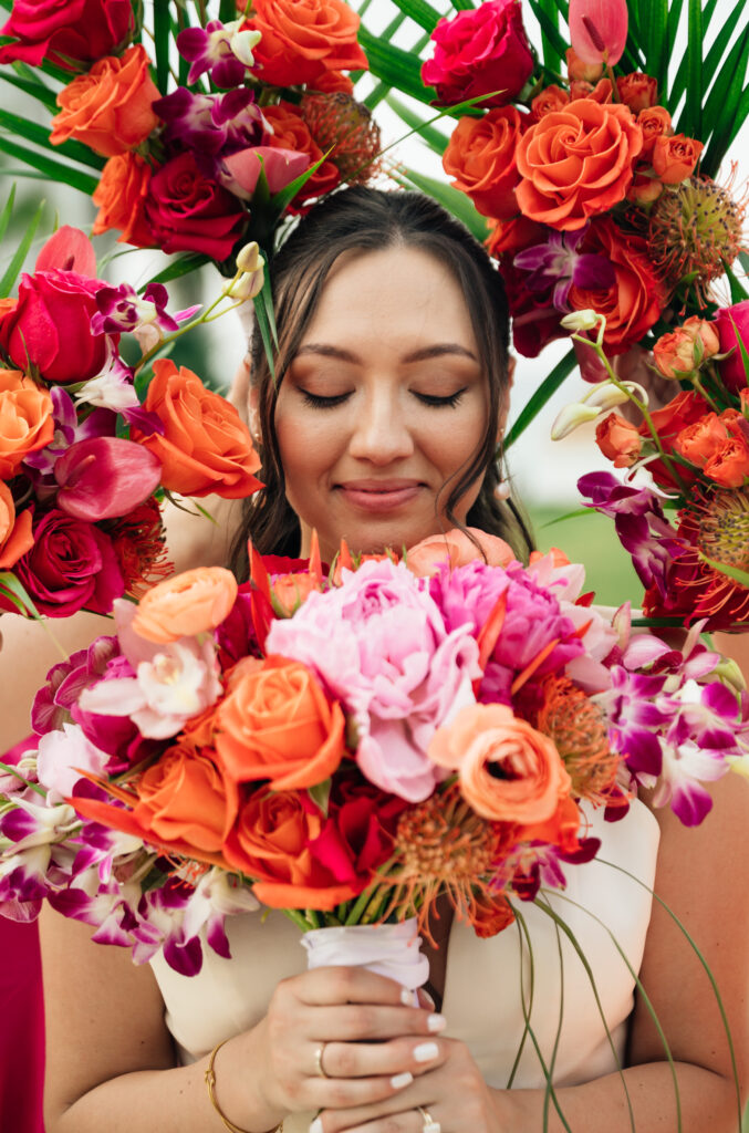 Bride wearing tropical flower crown with vibrant orange, pink, and purple blooms
